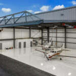 two white jets inside hangar