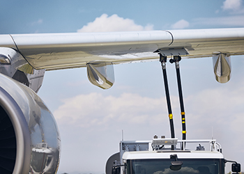 Plane being refueled with sustainable aviation fuel